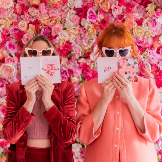 Natalie and Meg holding valentine's day cards