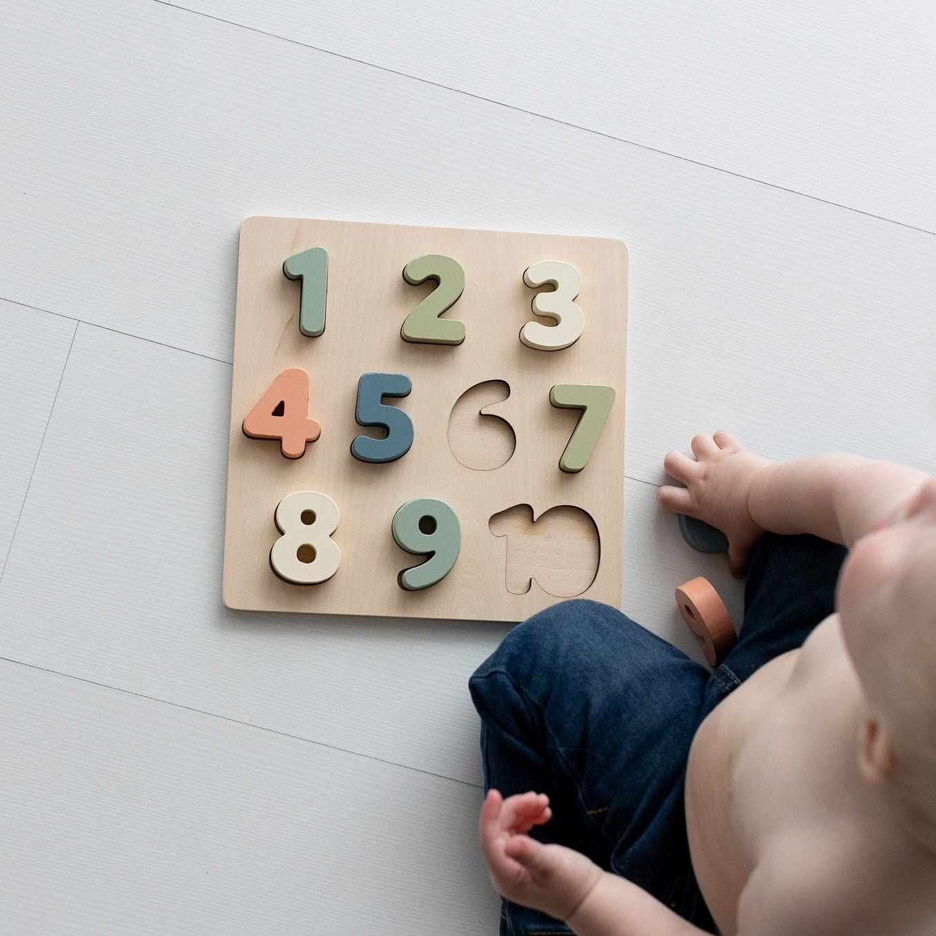 Baby playing with Wooden Number Puzzle 