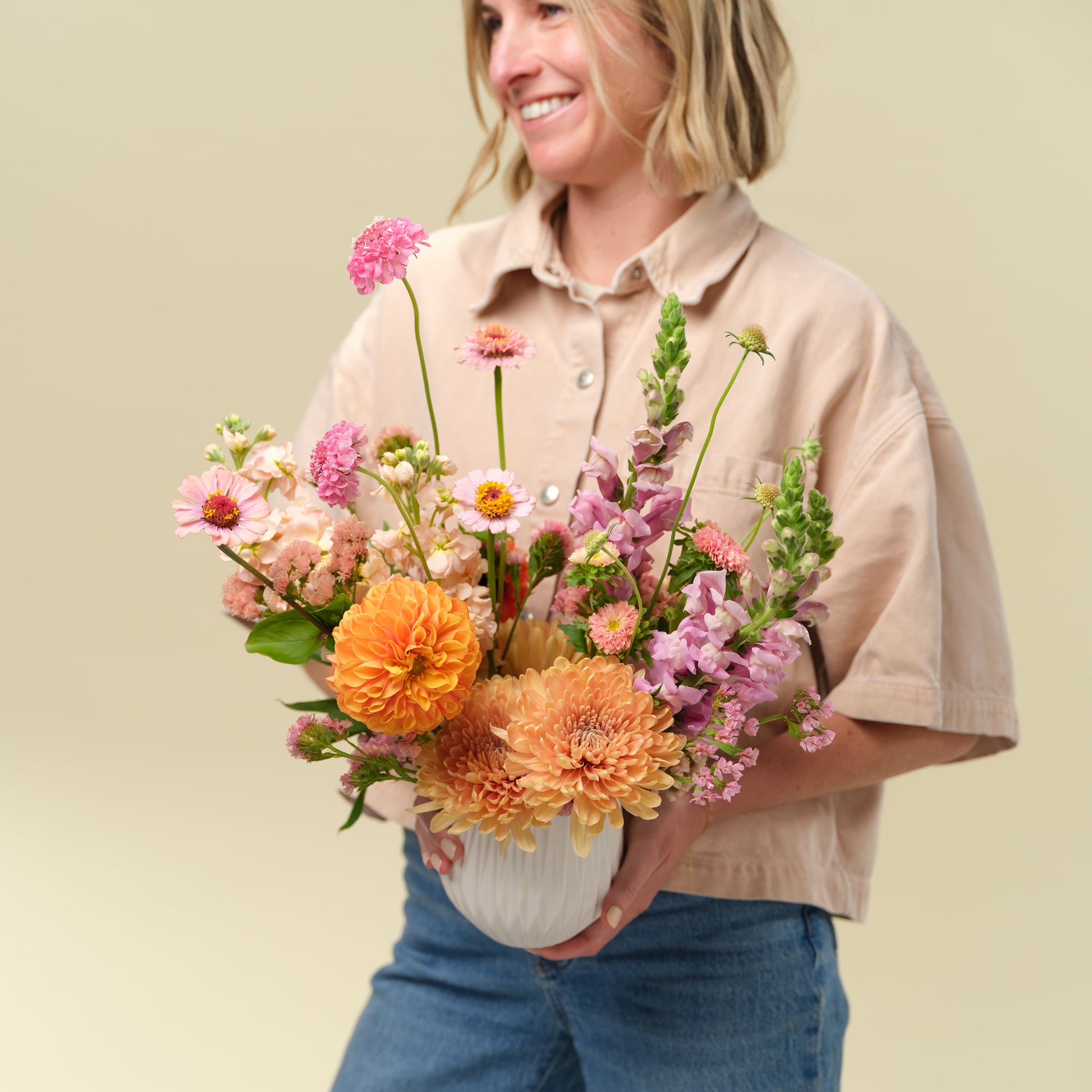 Natalie Gill holds Classic seasonal flower arrangement from Native Poppy