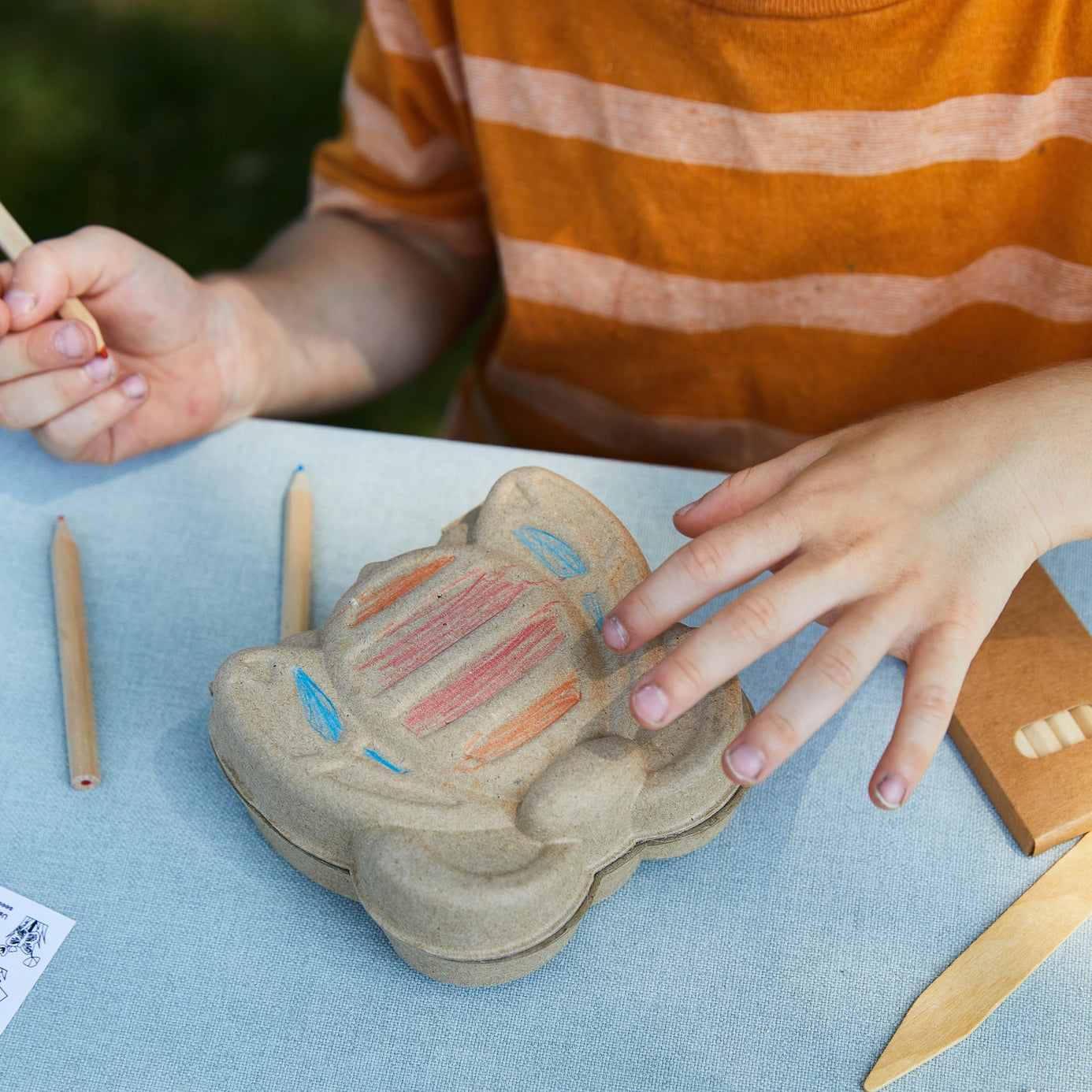 Child drawing on bumble bee Curious Critters Activity Kit