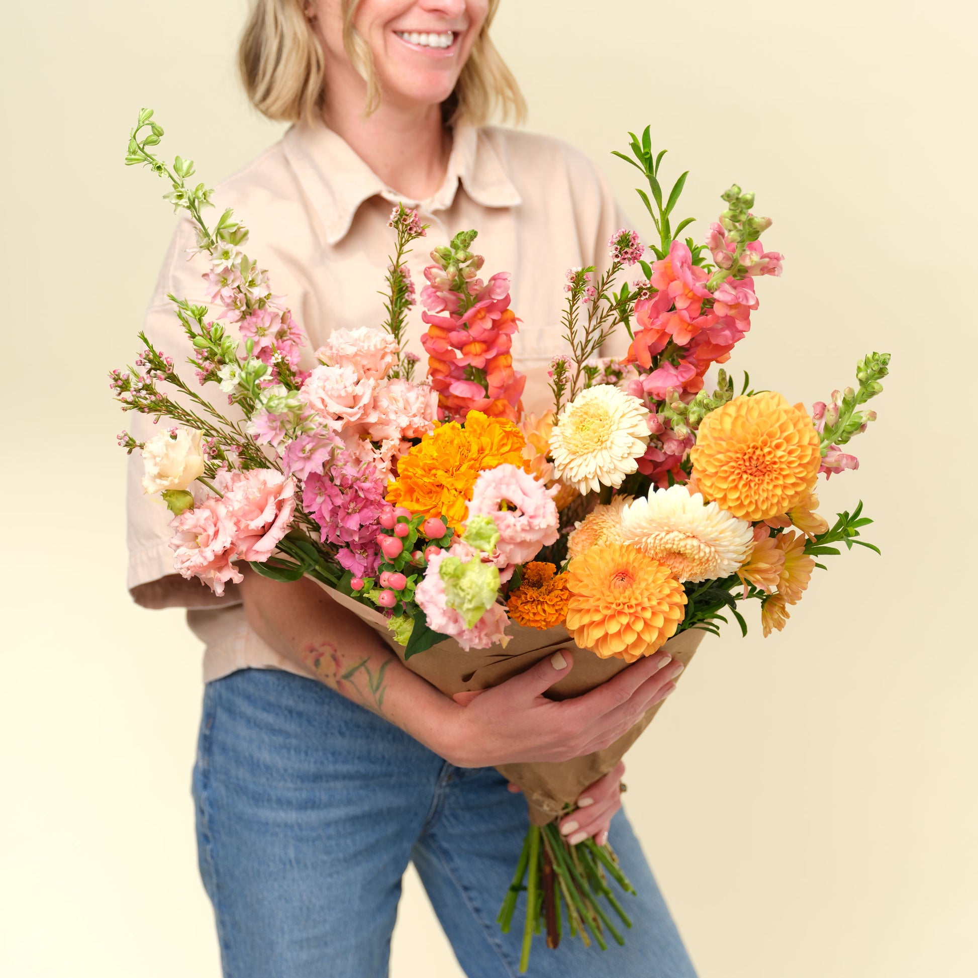 Woman holding an extra large bright + cheery flower wrap from Native Poppy