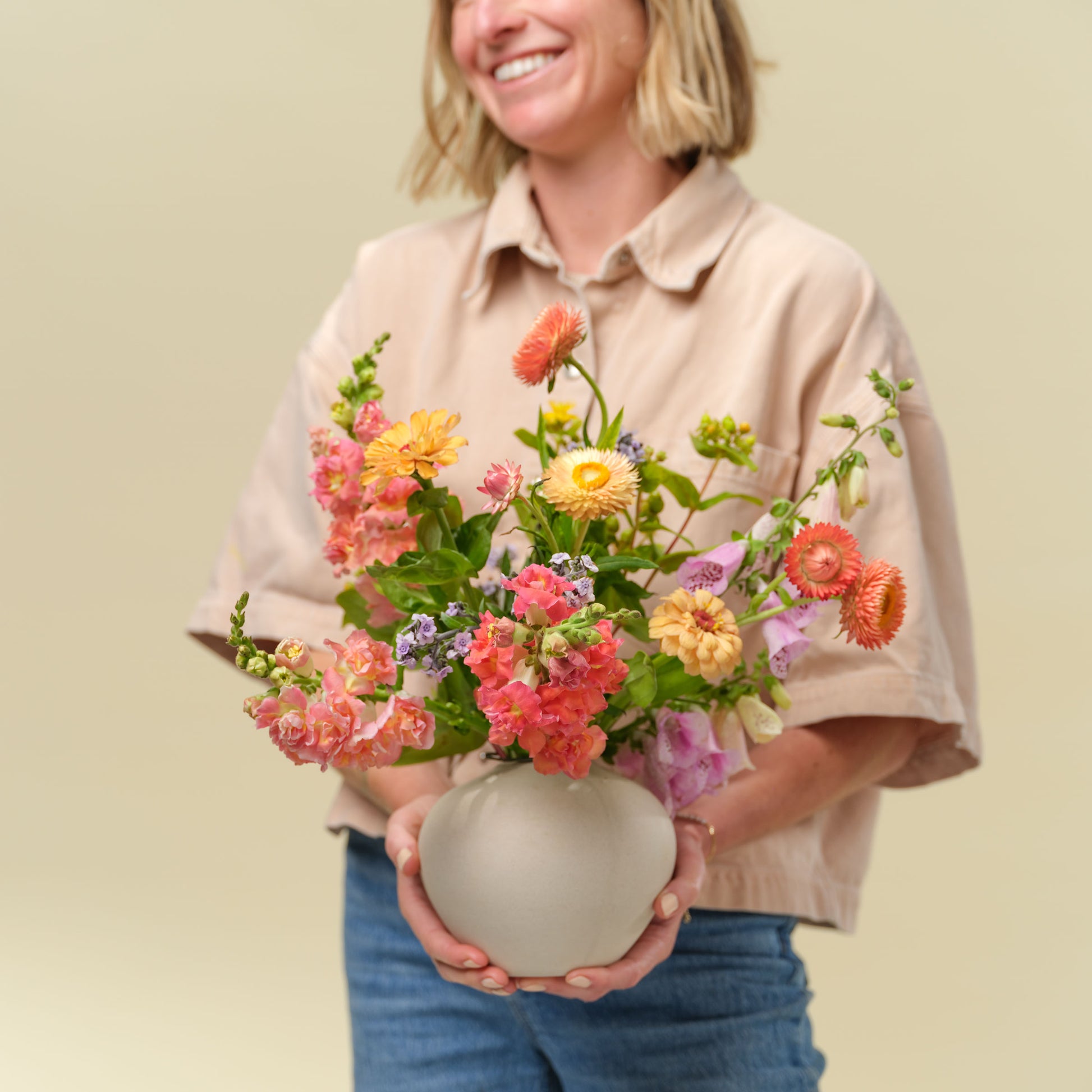 Natalie Gill holds a flower arrangement called the Garden Buddy