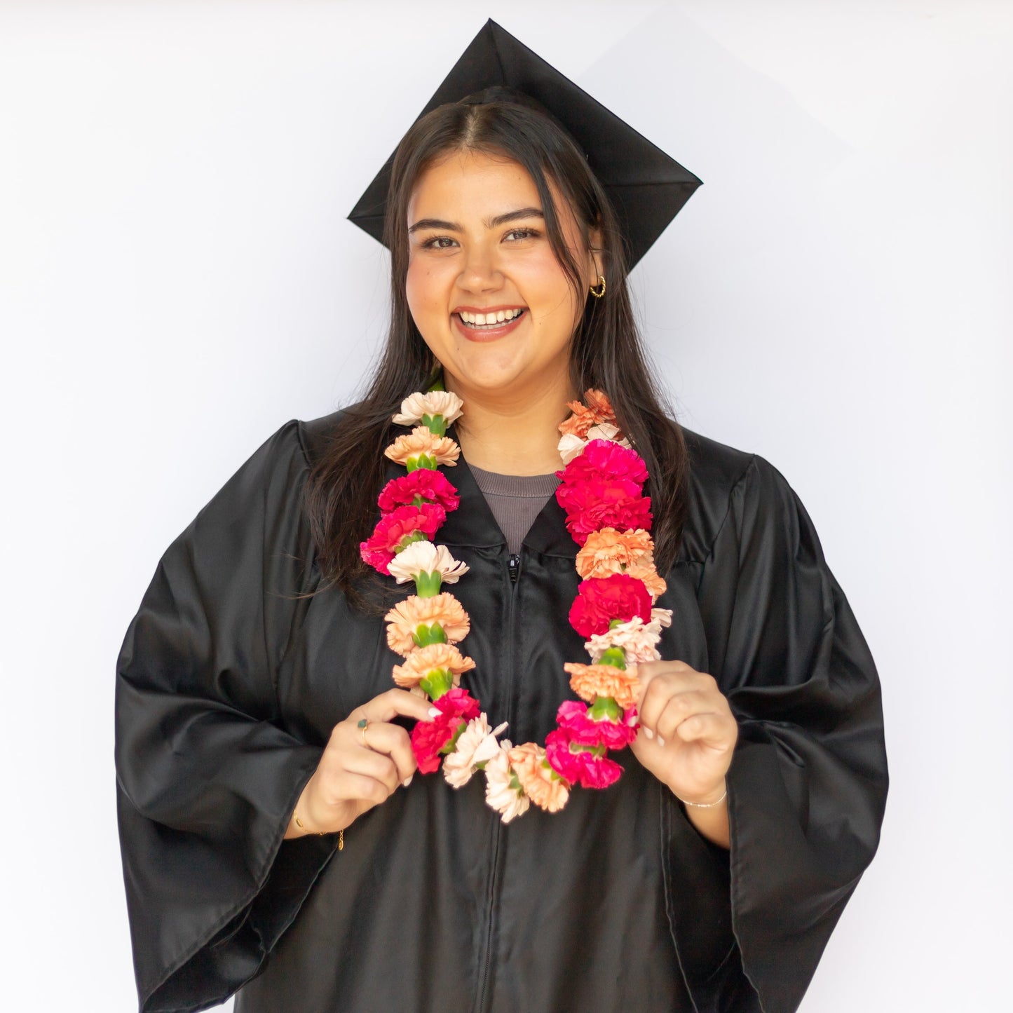 Grad wearing a bright and cheery flower necklace from Native Poppy