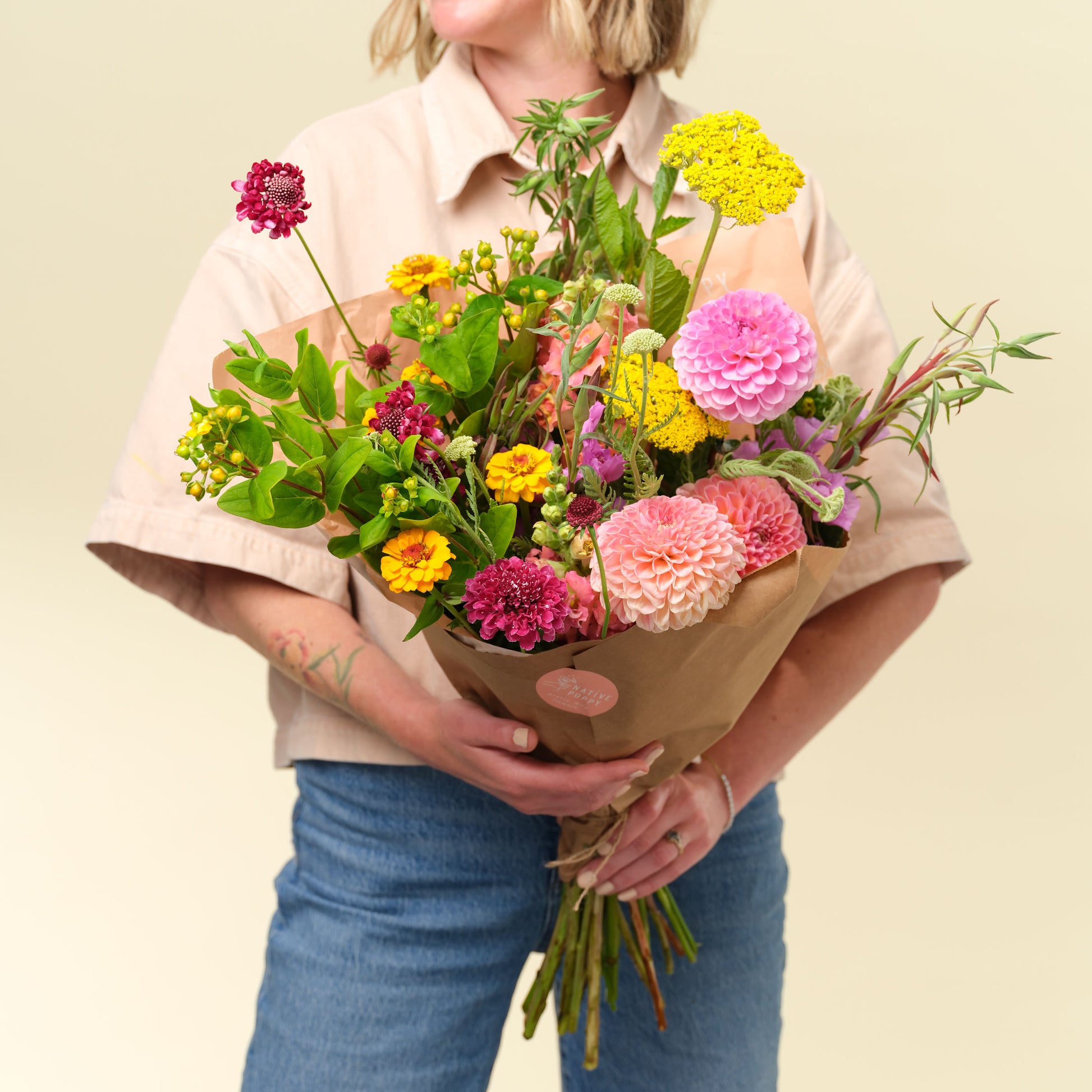 Woman holds Grand Locally-Grown Flower Wrap from Native Poppy in Fall 2024