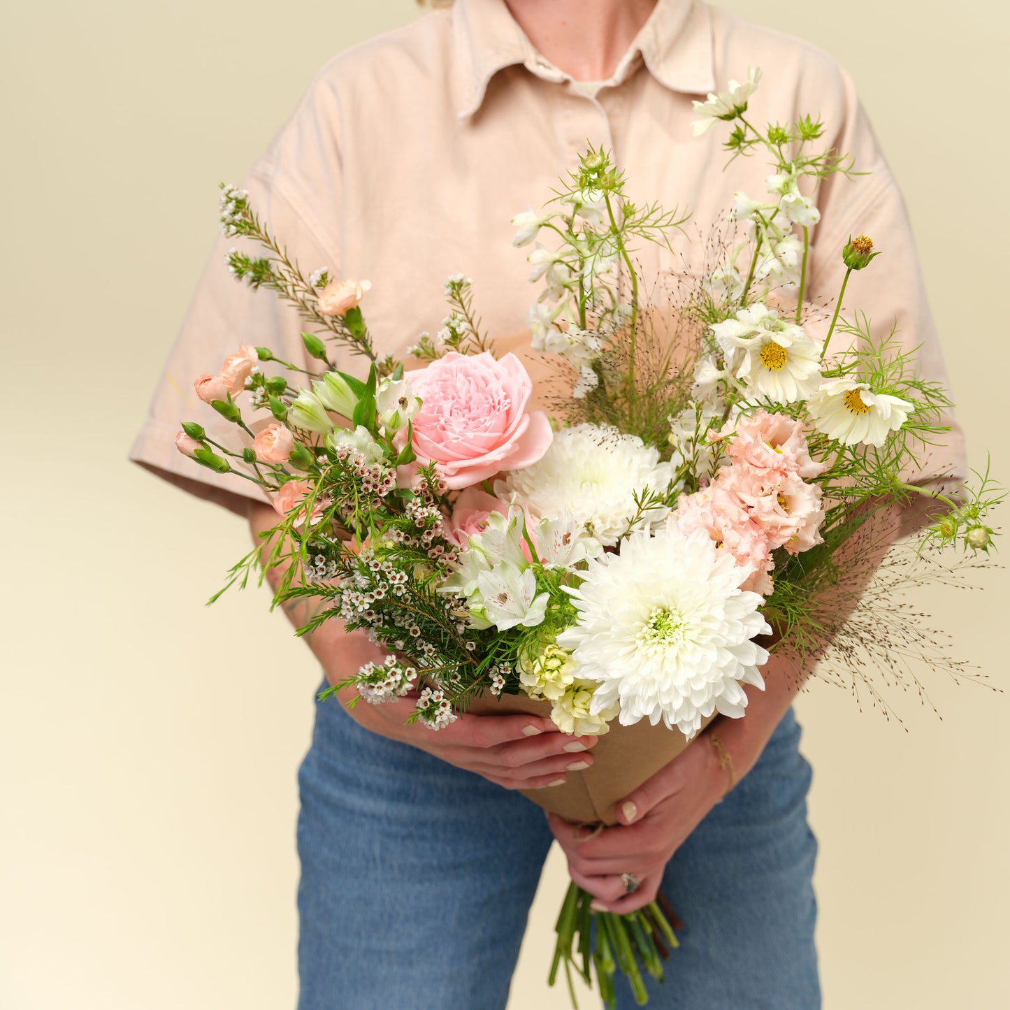 Woman holding Grand Neutral and elegant flower wrap from Native Poppy