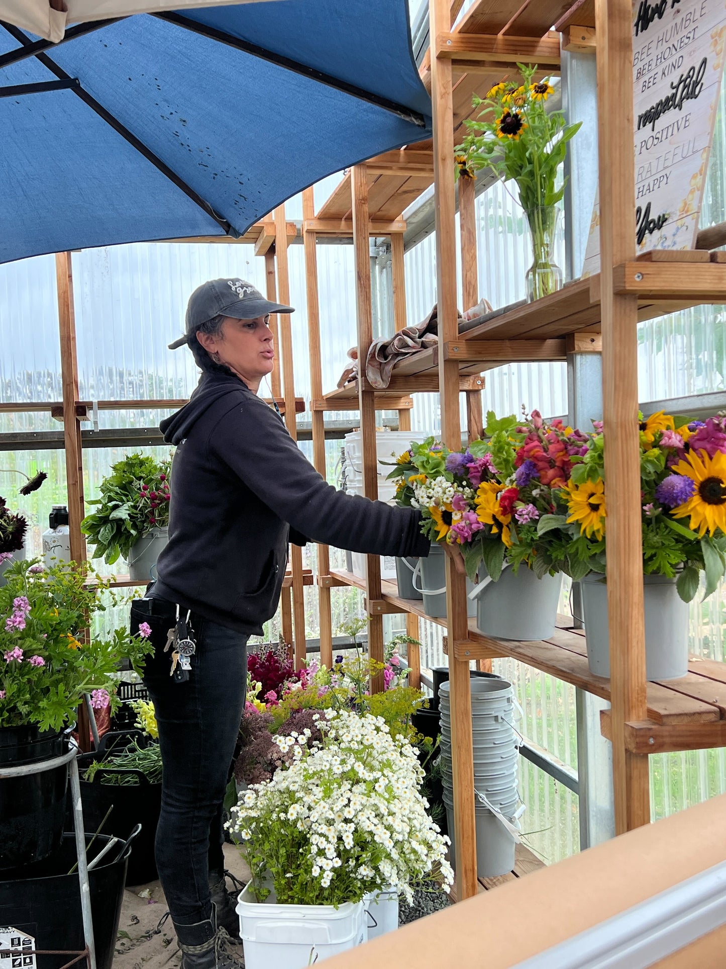 Flower farmer organizing buckets of flowers at BeeWorthy farm