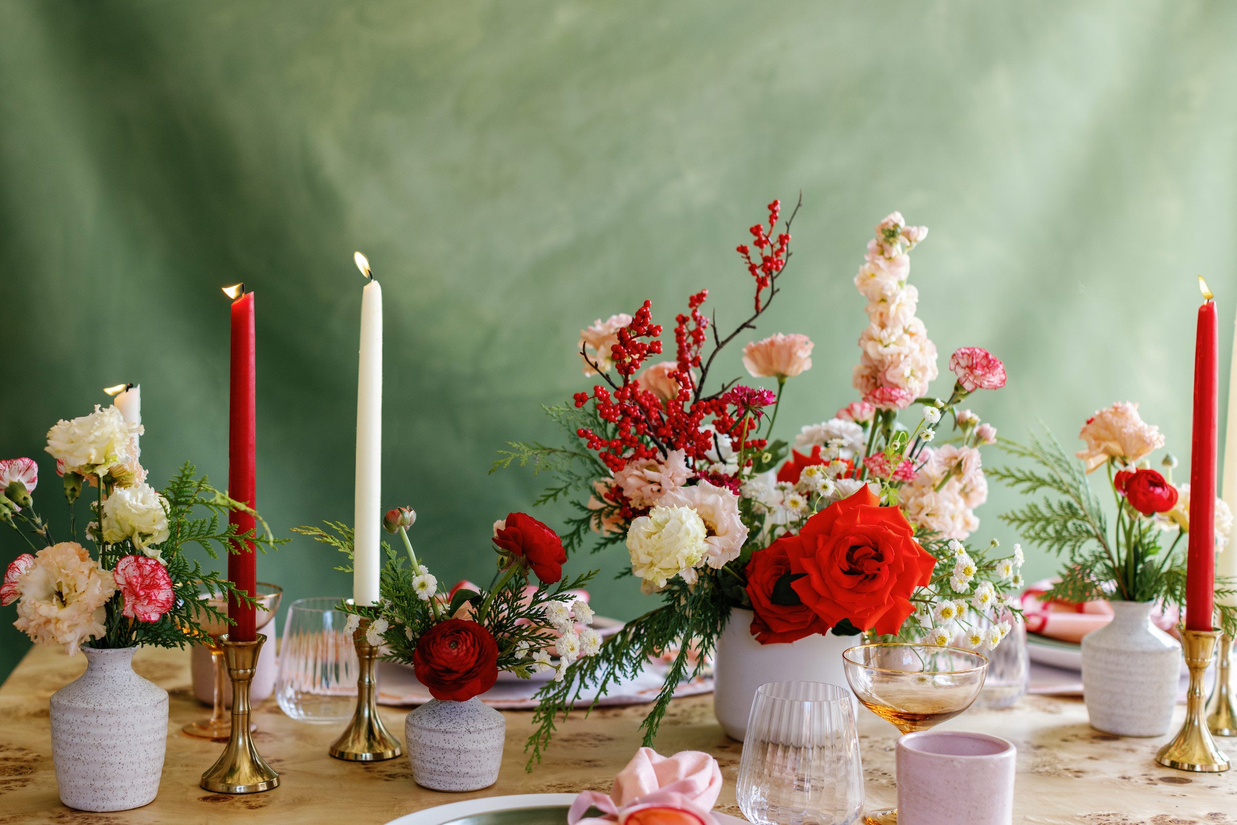 Red, pink, and white holiday flower centerpieces from Native Poppy