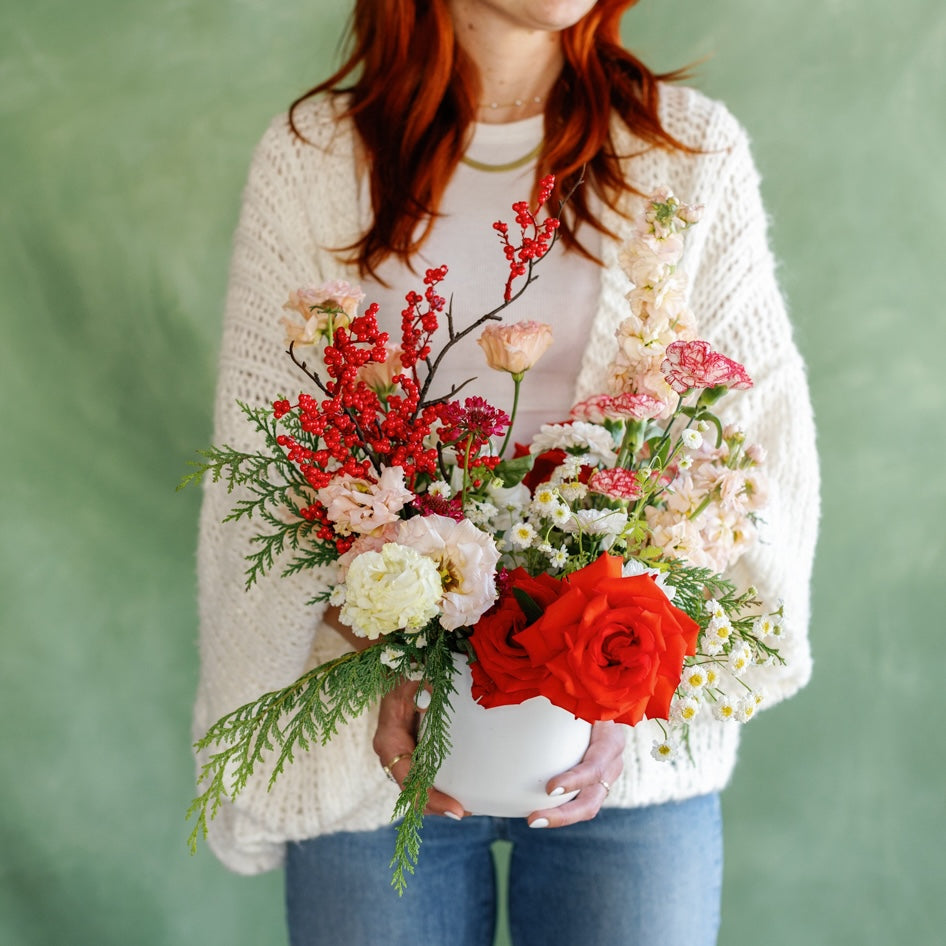 Meg Blancato holds Holiday flowers from San Diego Flower Shop Native Poppy