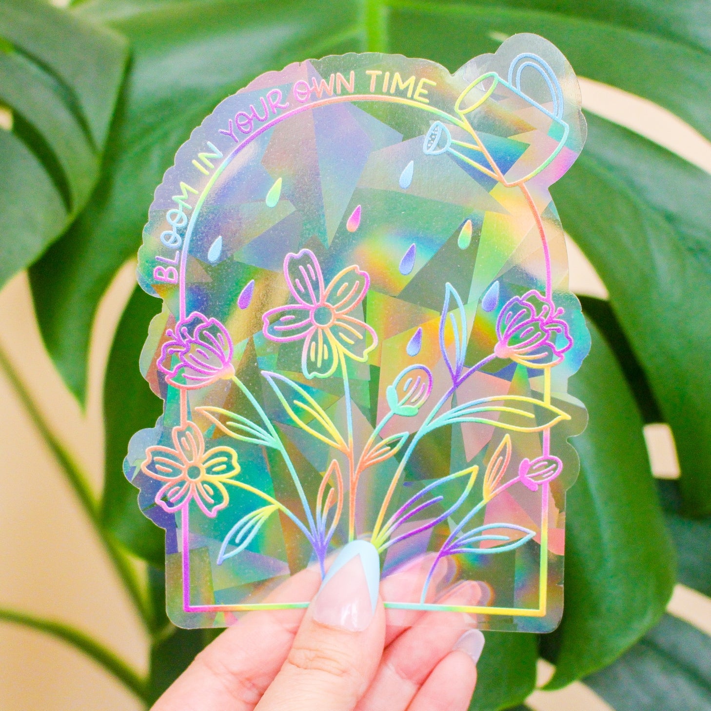 artist Julia Kestner holding Bloom in Your Own Time - Rainbow-Making Suncatcher