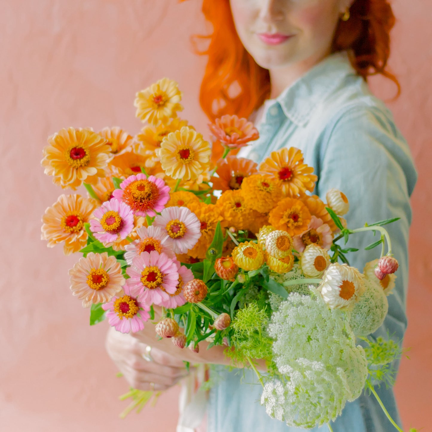 Meg holds summer flowers for the Local Flower Arranging 101 Workshop + Farm Tour