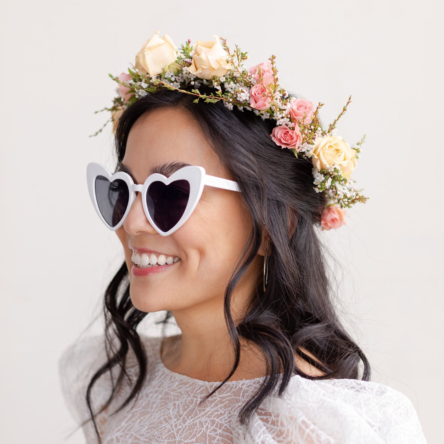 Bride wearing heart shaped sunglasses models the Lucy Flower Crown