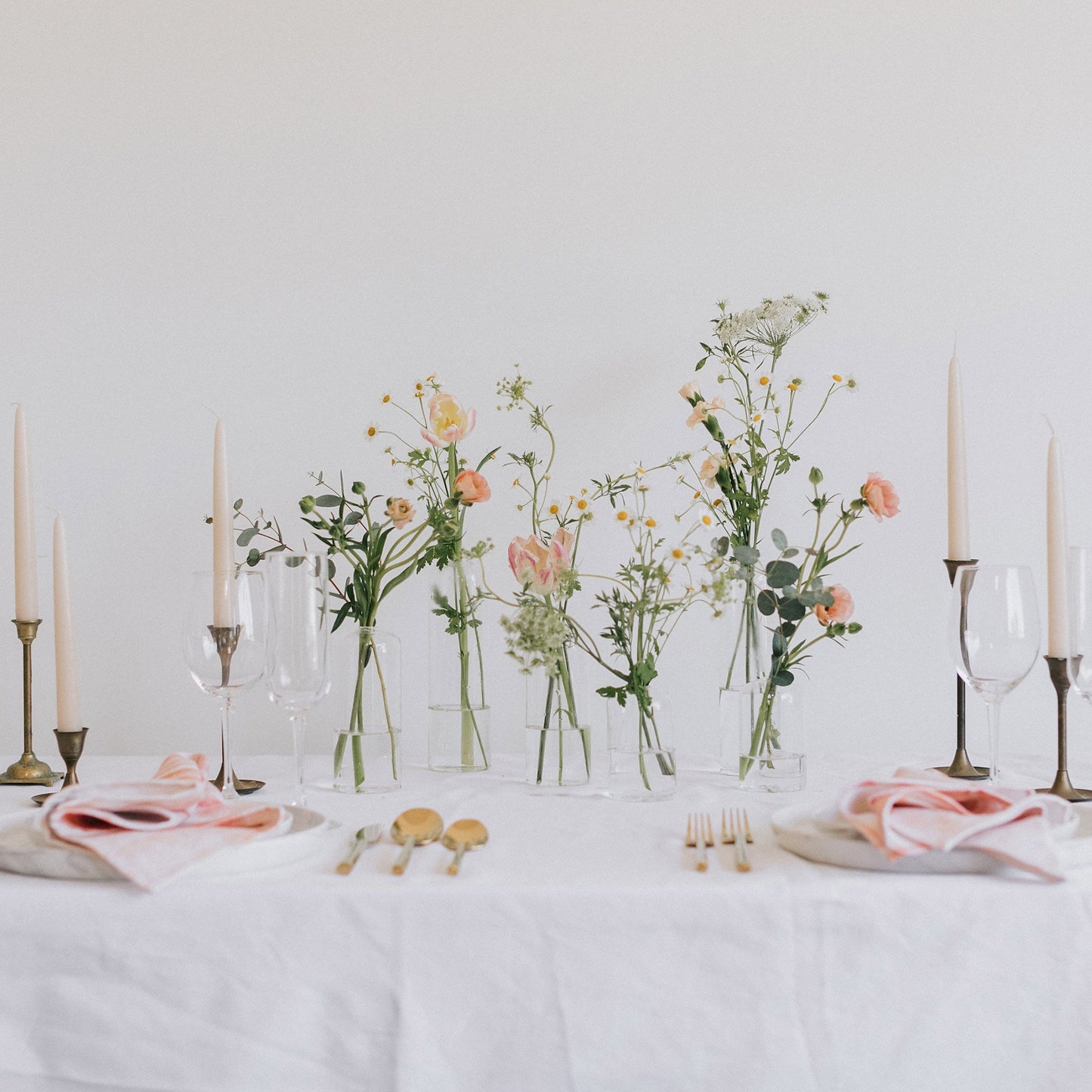 Glass Bud Vases with pink flowers on a formal table