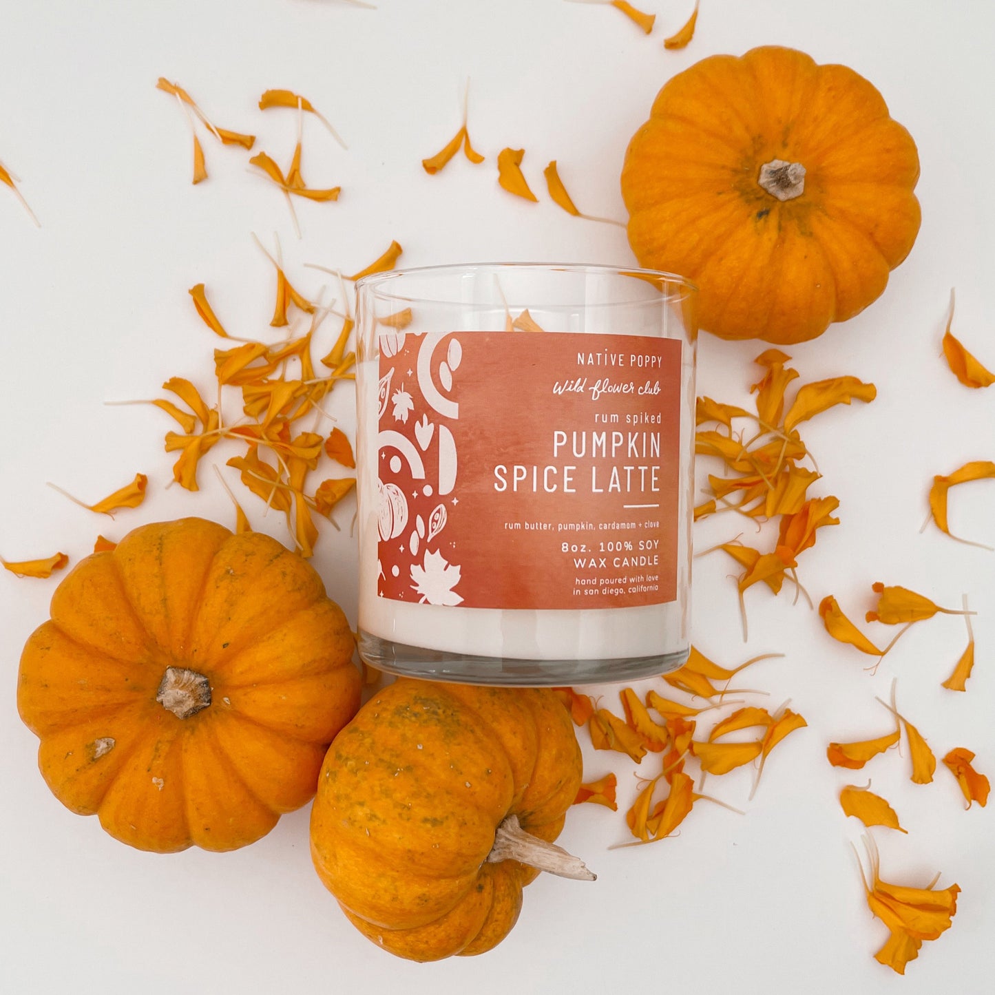 Pumpkin spice latte candle from Native Poppy with flower petals and mini pumpkins